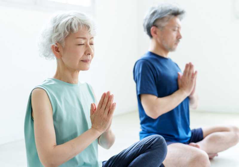 senior couple practicing meditation